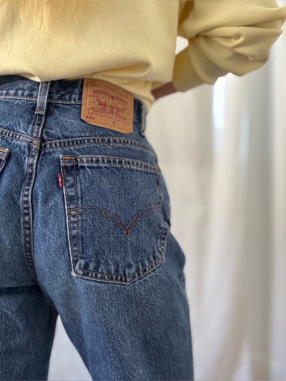 Vintage Levi’s 550 dark indigo relaxed hip raw hem 1990s